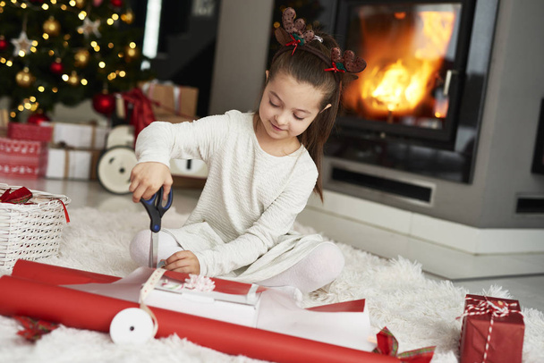 Little girl packing Christmas gifts - Photo, image