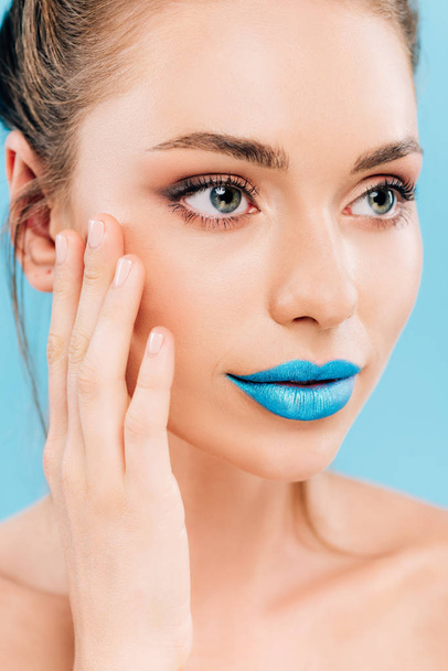 naked beautiful woman with blue lips touching face isolated on blue - Photo, Image