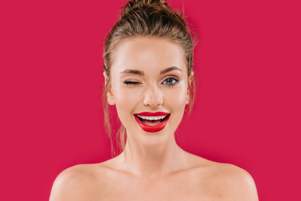 smiling naked beautiful woman with red lips winking isolated on red - Fotoğraf, Görsel