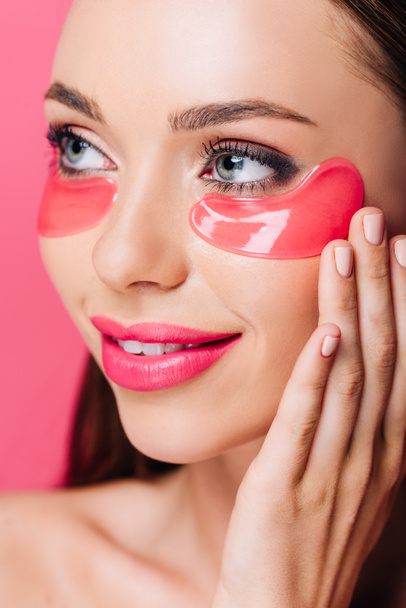 smiling naked beautiful woman with eye patch on face isolated on pink  - Photo, Image