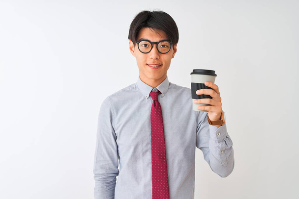 Chinese businessman wearing tie and glasses drinking coffee over isolated white background with a happy face standing and smiling with a confident smile showing teeth - Fotó, kép