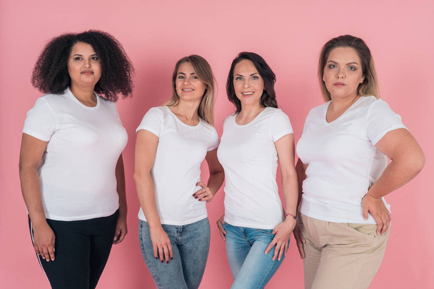 Two plus-size models and two skinny girls in white t-shirts. Design on white womens t-shirts - Zdjęcie, obraz