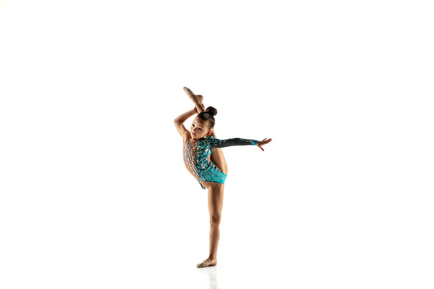 Little flexible female gymnast isolated on white studio background - Fotó, kép