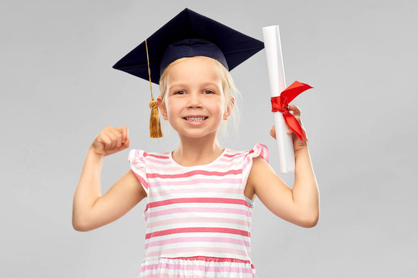 little girl in mortarboard with diploma - Foto, Imagem