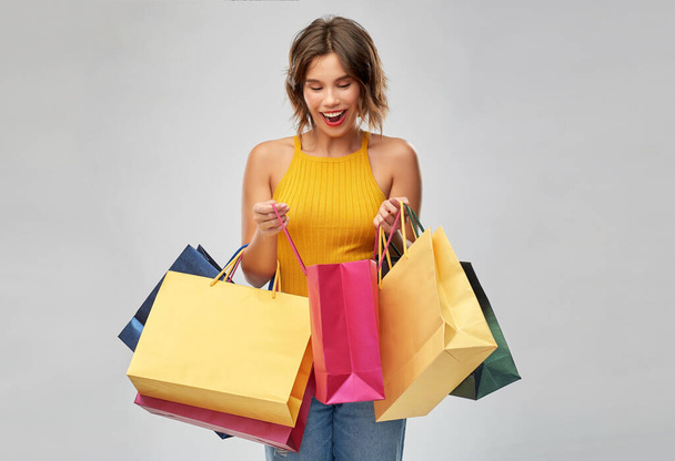 happy smiling young woman with shopping bags - Zdjęcie, obraz
