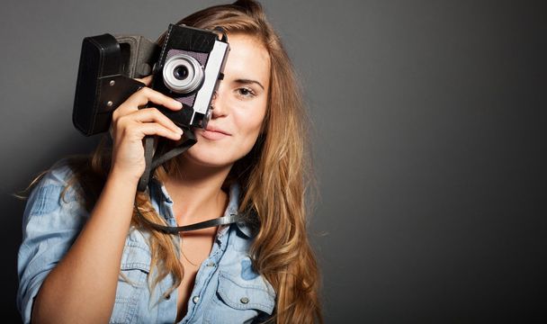 Smiling photographer woman with old camera - Foto, imagen