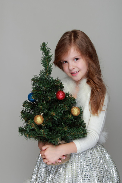 Girl holding a Christmas decoration - Φωτογραφία, εικόνα