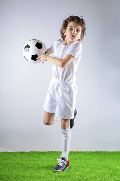 Soccer child in action.Young boy gets ready to throw a soccer ball - Φωτογραφία, εικόνα