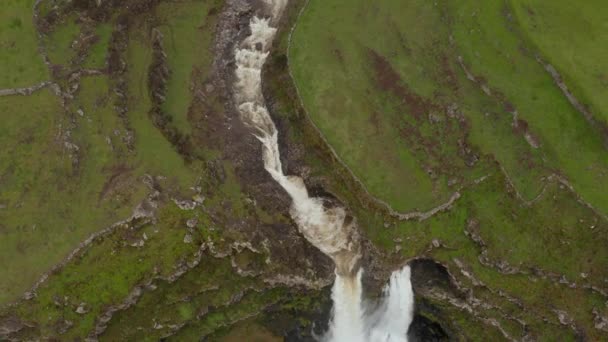 River flows in gorge between fields and falls as waterfall into the sea. Aerial of San Miguel island, Azores - 映像、動画