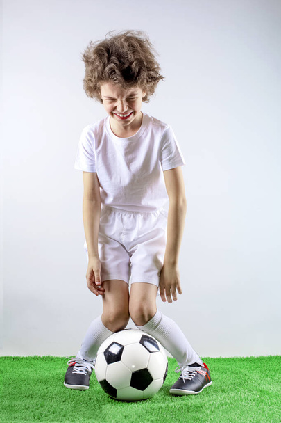 Fan sport boy player hold soccer ball celebrating happy smiling laughing free text copy space isolated on a gray background - Photo, Image
