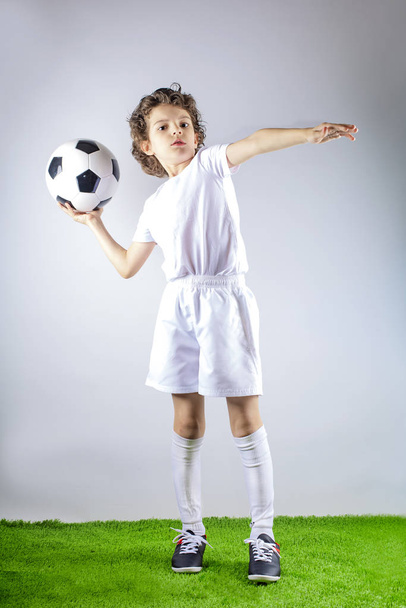 Soccer child in action.Young boy gets ready to throw a soccer ball - Zdjęcie, obraz