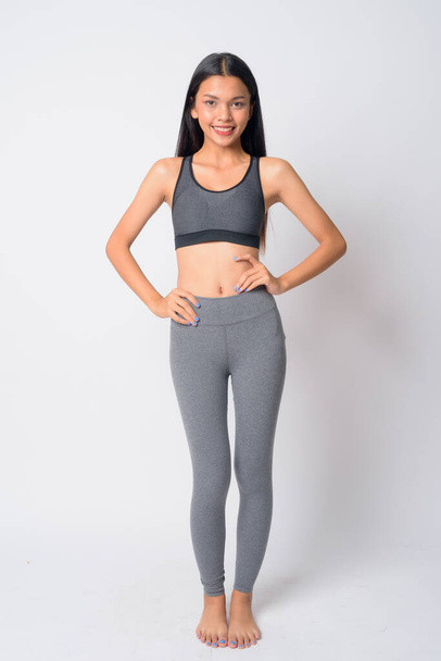 Full body shot of happy young Asian woman smiling ready for gym - Foto, immagini