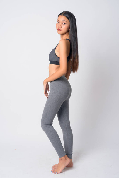 Full body shot profile view of young Asian woman ready for gym - Photo, Image
