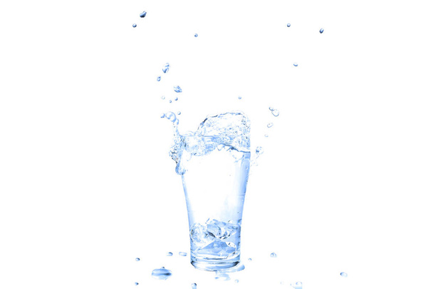 Ice cubes splashing into glass of water. - Valokuva, kuva
