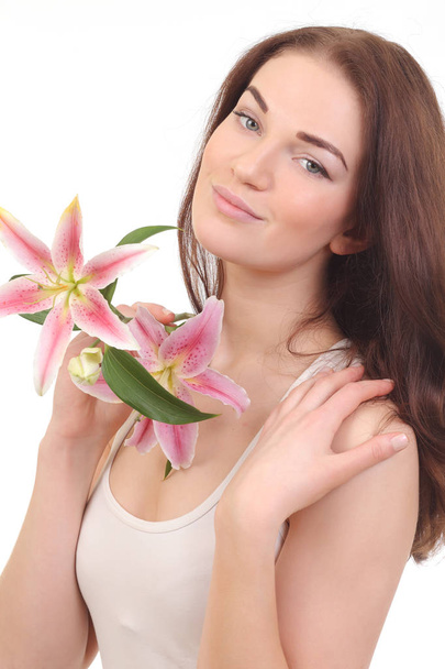 Cara de belleza de mujer con flor de lirio
 - Foto, Imagen