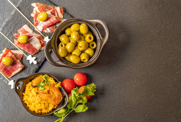 Spanish tapas, Iberian ham, Valencian paella and olives - Фото, зображення