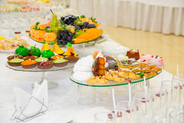 Various fruits, desserts, pastries on the holiday table. New year or Christmas. - Foto, imagen