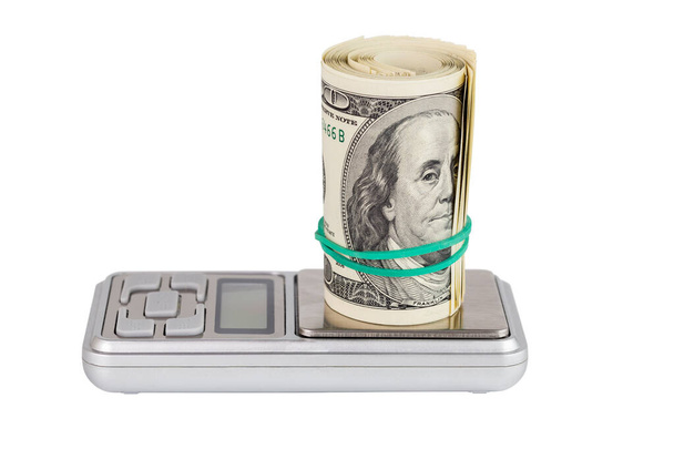 un rollo de nosotros dólar en peso de bolsillo electrónico aislado sobre fondo blanco
 - Foto, Imagen