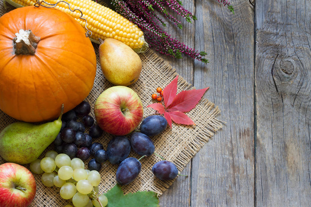 Pumpkin with autumn vegetables and fruits on vintage boards - Fotoğraf, Görsel