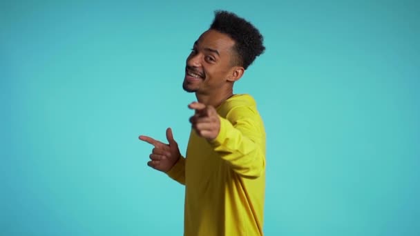 Young african american man smiling and dancing in good mood on blue background.Unstoppable fun, happiness, comical portrait of guy isolated. - Séquence, vidéo