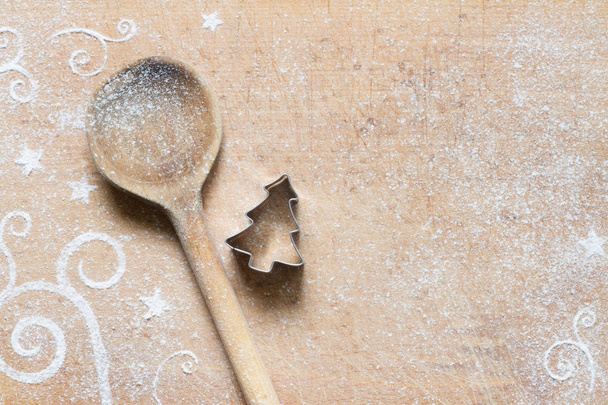 Abstract Christmas food background with cookie mold, spoon and flour - Foto, afbeelding