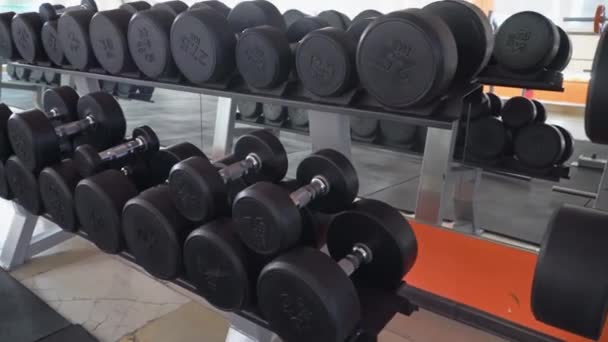 row of dumbbells in a modern gym - Footage, Video