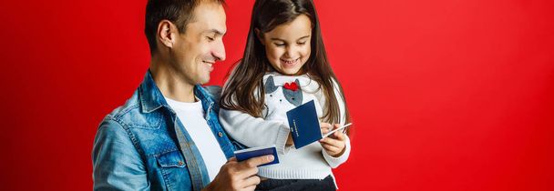 portrait of father and pretty daughter with new passports - Photo, Image
