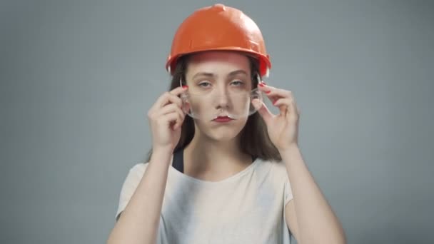 Video of woman in orange helmet and glasses - Materiał filmowy, wideo