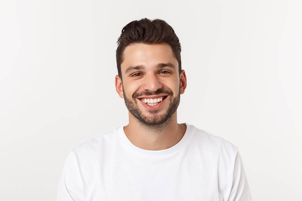 Πορτραίτο ενός όμορφου νεαρού άνδρα χαμογελώντας σε κίτρινο φόντο - Φωτογραφία, εικόνα