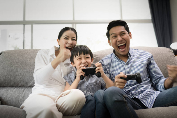 emotion of young family, father, mother and son watching TV and  - Photo, Image