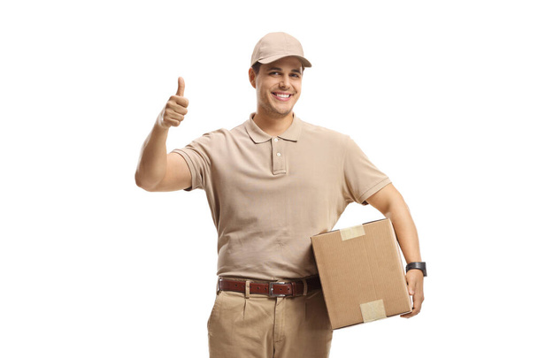 Postman holding a package and making a thumb up sign  - Foto, afbeelding