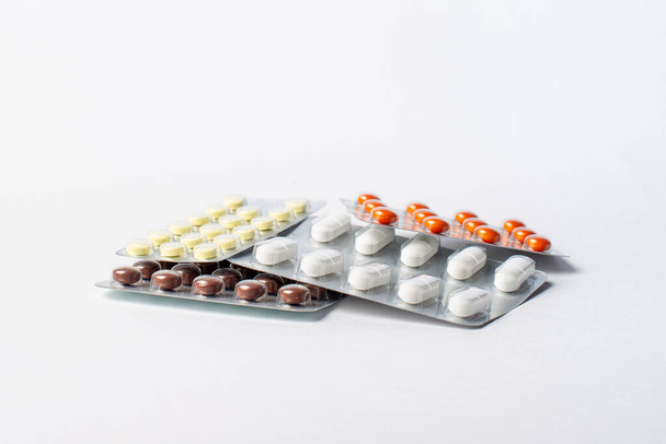 μια στοίβα φουσκάλες με χάπια χρώμα σε λευκό φόντο - Φωτογραφία, εικόνα