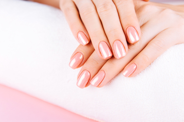 Beautiful Woman Hands . Spa and Manicure concept. Female hands with pink manicure. Soft skin skincare concept. Beauty nails. Over beige background. - Photo, Image