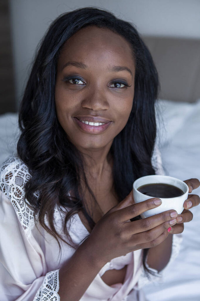 Woman is drinking coffee in bed - Zdjęcie, obraz