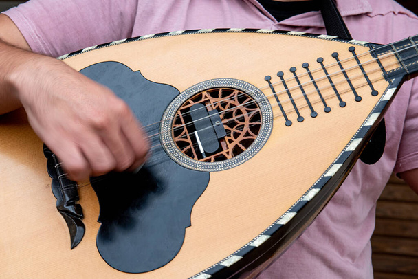 Musician playing a traditional song with the laouto, lute,  a tr - Photo, Image