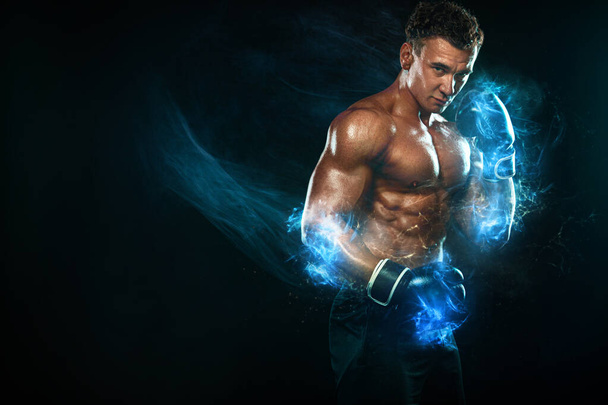 Fitness and boxing concept. Boxer man fighting or posing in gloves on black background. Individual sports recreation. Energy and power. - Φωτογραφία, εικόνα