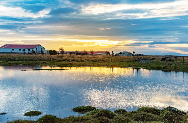 Old farm and small lake in Iceland on sunrise. - 写真・画像