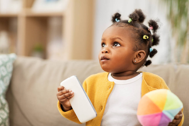 african american baby girl with smartphone at home - Foto, Imagem