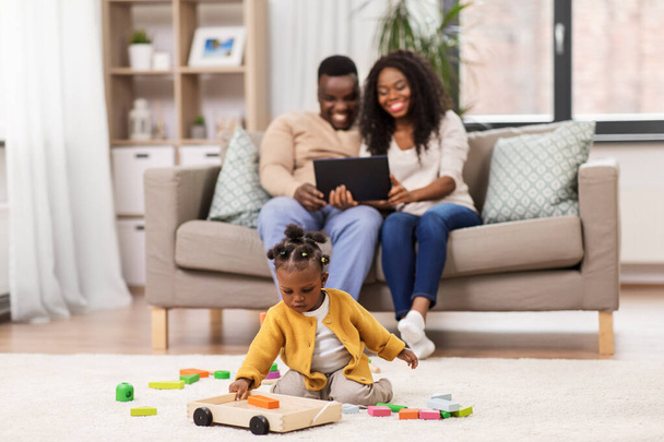 family with tablet pc and toy blocks at home - Photo, Image