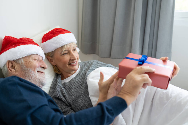 senior elderly caucasian old man give gift presents to woman, th - Photo, Image