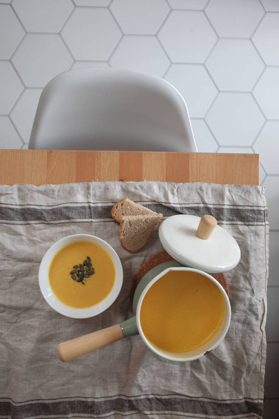 pumpkin cream soup on a wooden table. View from above. Healthy eating concept - Zdjęcie, obraz