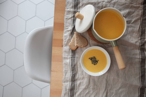 pumpkin cream soup on a wooden table. View from above. Healthy eating concept - Fotografie, Obrázek