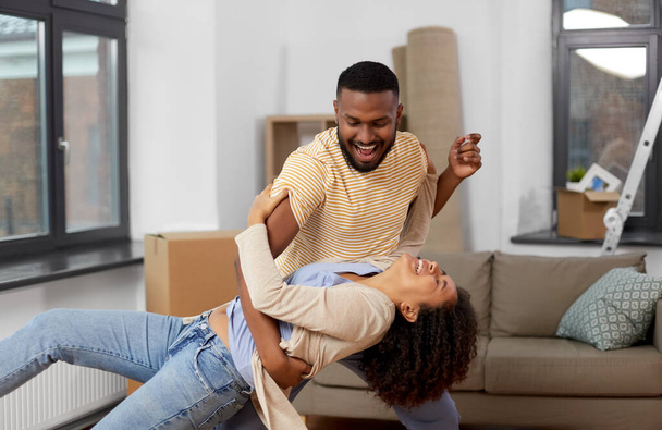 happy couple moving to new home and dancing - Foto, Imagem