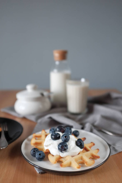 Viennese waffle with ice cream and blueberries. View from above. Breakfast concept. - Fotoğraf, Görsel