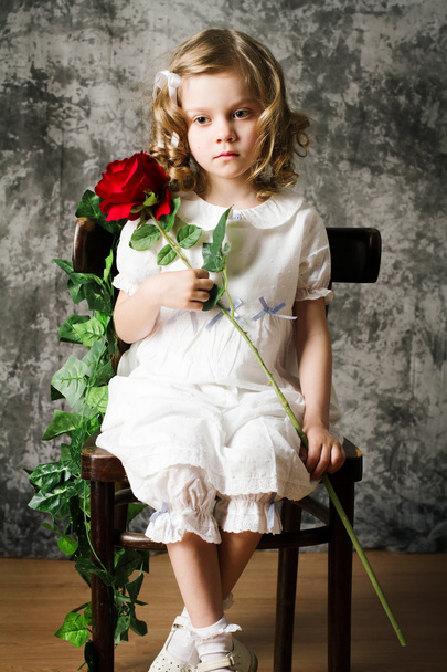 Portrait of curly girl with rose - Фото, изображение