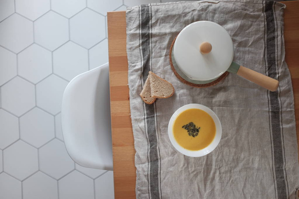 pumpkin cream soup on a wooden table. View from above. Healthy eating concept - 写真・画像