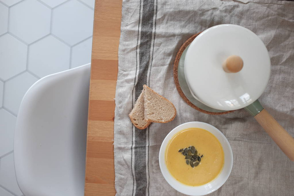 pumpkin cream soup on a wooden table. View from above. Healthy eating concept - 写真・画像