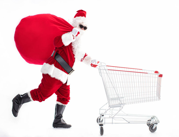 Happy Santa Claus with Christmas shopping cart - Foto, Imagen