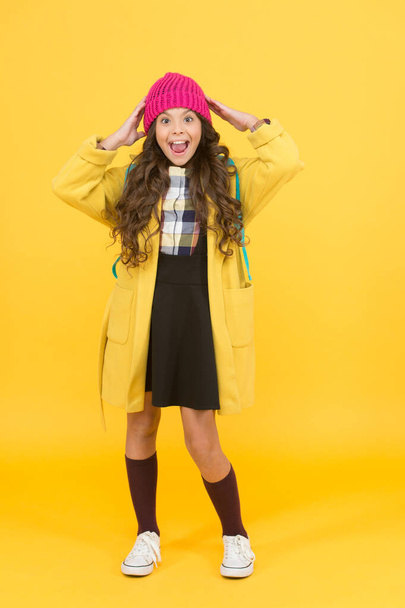 Fashion for enjoying school life to fullest. Happy child wear fashion style yellow background. Fashion look of small girl. Fashion trends for school - Foto, afbeelding