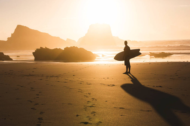 Surfer checking the waves at sunset - Foto, Imagen
